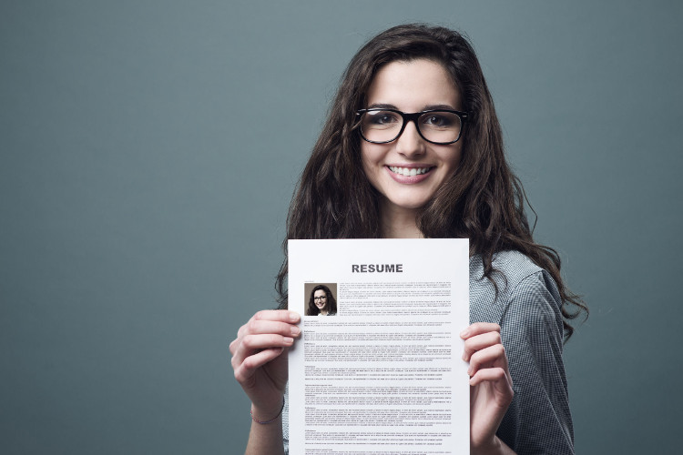 Job seeker holding up resume